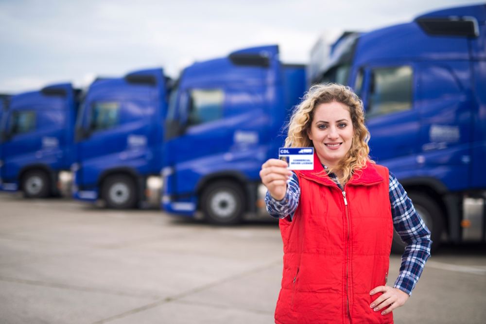 woman holding her commercial drivers license